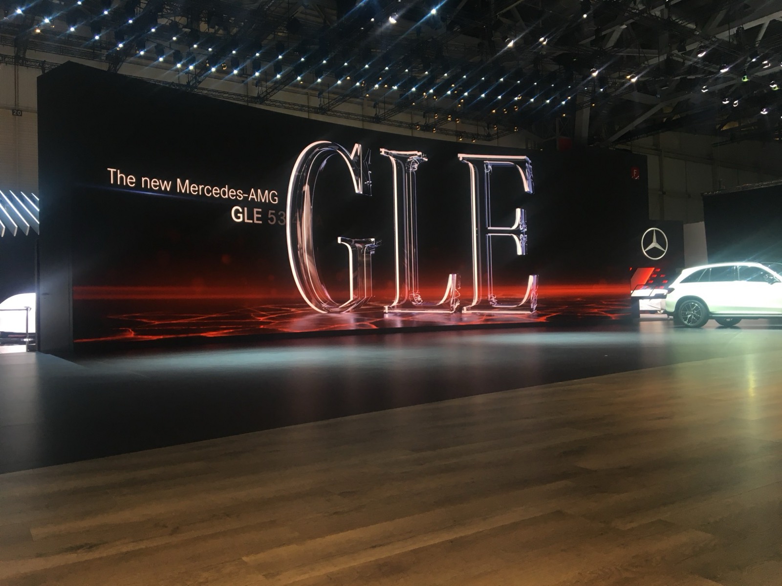 Wide LED wall on a trade show stand with large 3D lettering